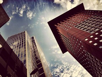 Low angle view of modern building against cloudy sky