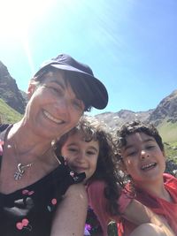 Portrait of smiling woman against mountains