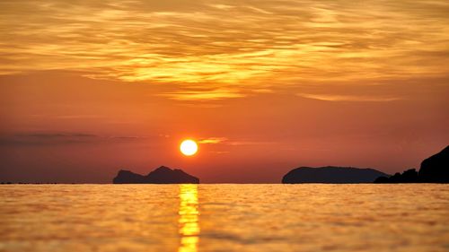 Scenic view of sea against orange sky