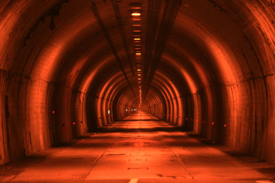 Empty corridor in illuminated tunnel
