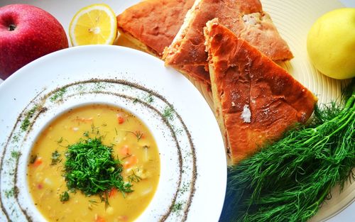 Directly above shot of soup served in bowl with bread