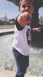 Portrait of boy standing in water