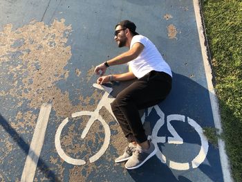 High angle view of man with bicycle on road