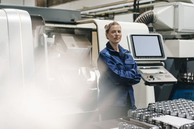 Young woman working as a skilled worker in a high tech company, portrait