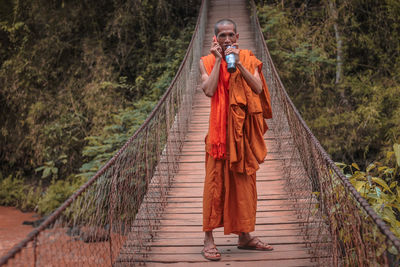 Full length of man standing on bridge