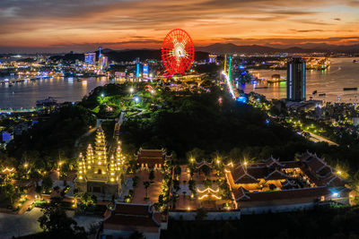 High angle view of illuminated buildings in city at night