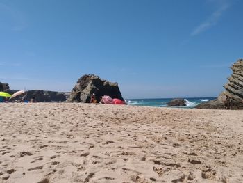 Scenic view of beach against clear sky