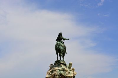 Low angle view of historic statue against sky