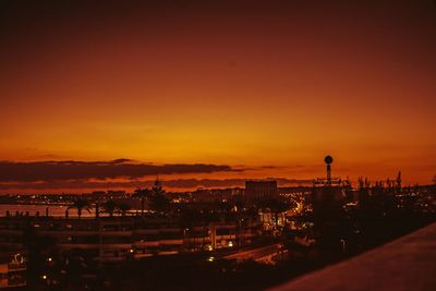 High angle view of illuminated buildings against sky during sunset