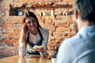 Waitress taking order of customer at cafe