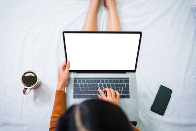 Directly above view of man using laptop on table