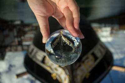 Cropped hand of woman holding crystal ball