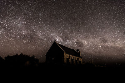 Silhouette building against sky at night