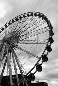 Low angle view of ferris wheel against sky