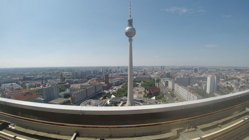 Aerial view of buildings in city against sky