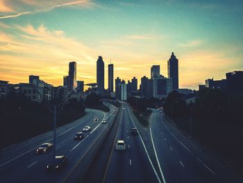 High angle view of street amidst buildings in city against sky