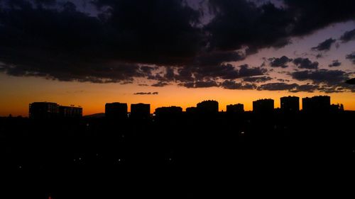 Silhouette cityscape against sky during sunset