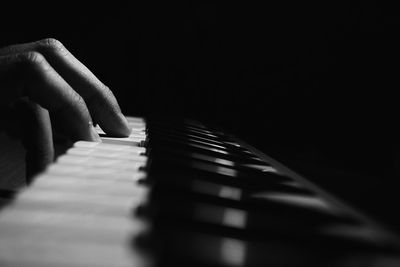Close-up of person playing piano