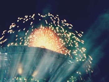 Low angle view of firework display at night