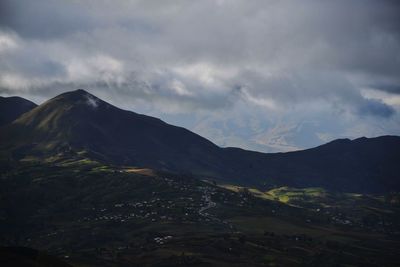 Scenic view of mountains against cloudy sky