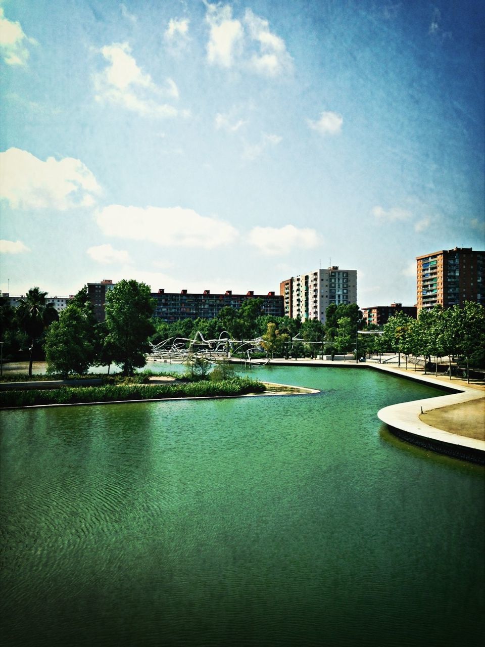 water, architecture, built structure, building exterior, sky, waterfront, city, river, tree, blue, cityscape, cloud, cloud - sky, reflection, day, connection, nature, outdoors, no people, rippled