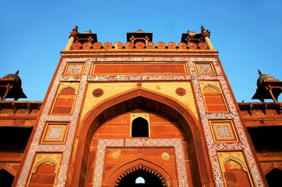 Low angle view of building against clear blue sky