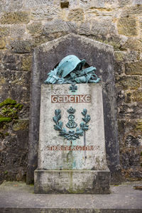 Low angle view of text on stone wall