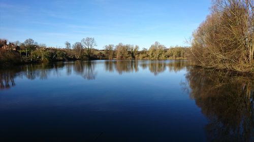 Scenic view of lake against blue sky