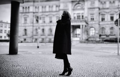 Woman walking on street in city