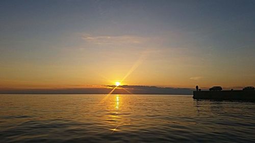 View of sailboat in sea at sunset