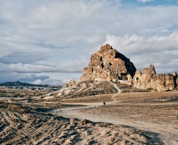 Rock formations on landscape against sky