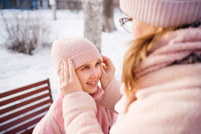 Mother and daughter happily embrace spring walk in the park sunny day