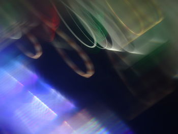 Close-up of hand on illuminated glass