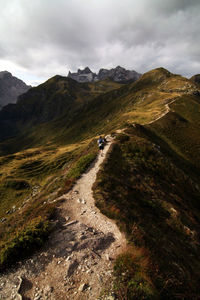 Distant view of male hiker hiking on mountain