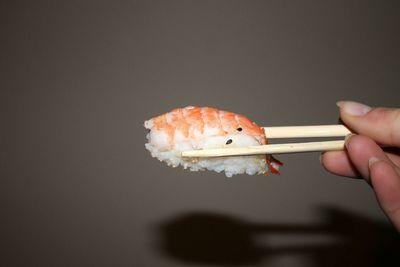 Close-up of hand holding sushi