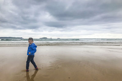 Portrait of boy standing at beach