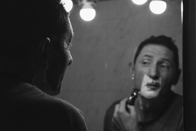 Portrait of a man shaving his face