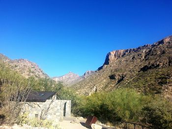 Scenic view of mountains against blue sky