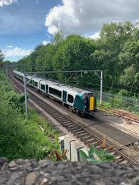 Train on railroad track against sky