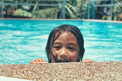Portrait of girl at poolside on sunny day