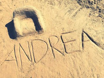 High angle view of text on sand at beach