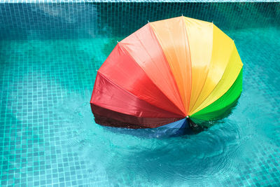 High angle view of multi colored umbrella on swimming pool