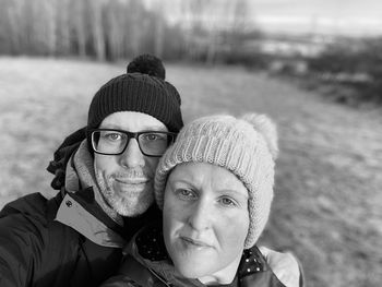 Portrait of smiling man and woman in snow