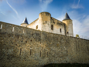 Low angle view of historic building against cloudy sky