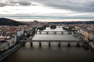 High angle view of bridge over river amidst buildings in city