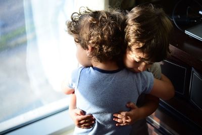 Siblings standing in building