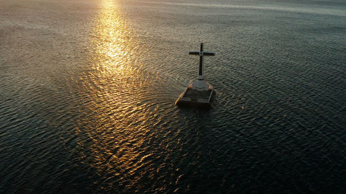 High angle view of cross on sea