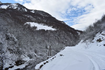 Scenic view of snow covered mountains against sky