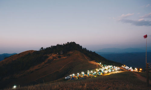 Scenic view of illuminated mountains against sky