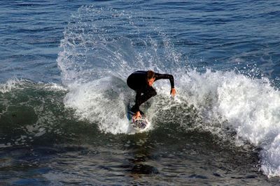 High angle view of man surfing on sea